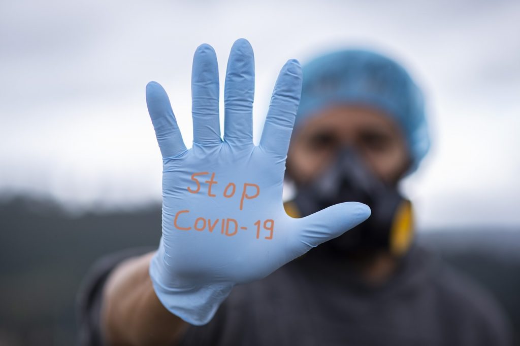 Stop COVID19 person wearing gloves and PPE equipment