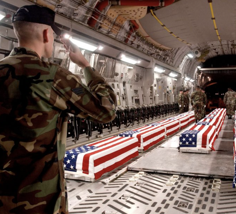 Image of caskets draped in American flags of remains of soldiers returned to America